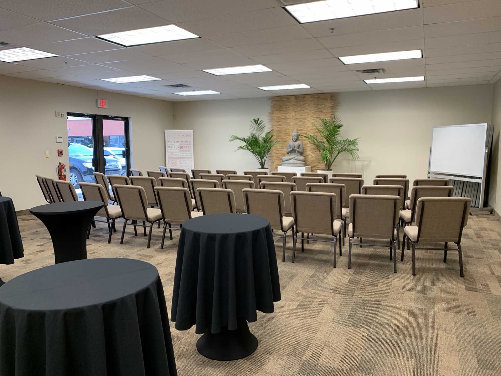 Multipurpose Room in Oakland Park with rows of chairs and black-linen high-top cocktail tables