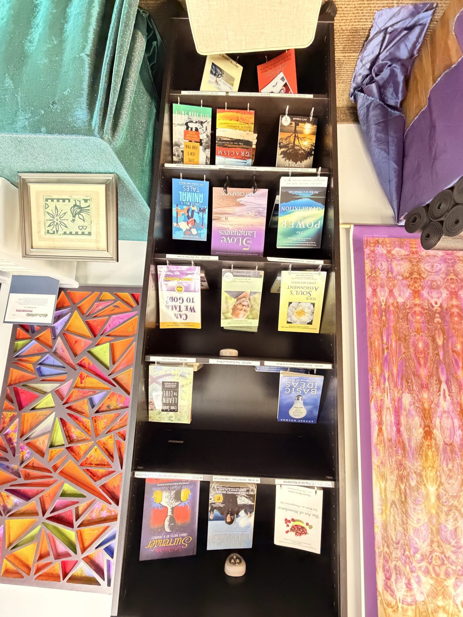 Spiritual books displayed face-out on a shelf